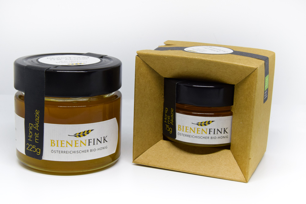 Two Honey Jars With Cardboard Packaging And Label Design