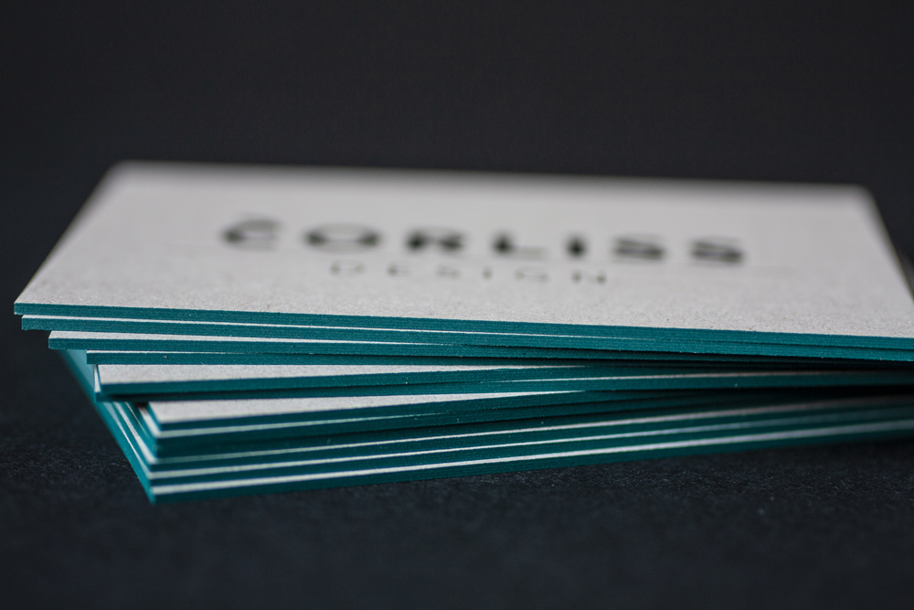 Corporate Design And Branding For Corliss Design, Here The Business Cards Are Shown: Close Up Of The Petrol Colored Edge On Grey Paper