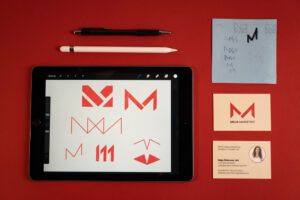 from logo sketch on paper to logo sketches on the ipad to the final business cards for brand identity design, by Corliss Design