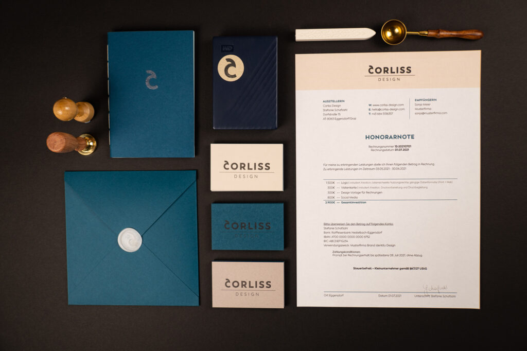 flatlay of the Brand Identity Design for Corliss Design, shown are the business cards, an A4 invoice paper, the stickers, the stamp, an envelope with a wax seal with the logo, the wax seal stamp and a hand-bound booklet with a logo embossing